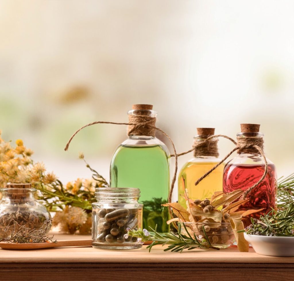 Dry herbs and herbal extracts in glass bottles